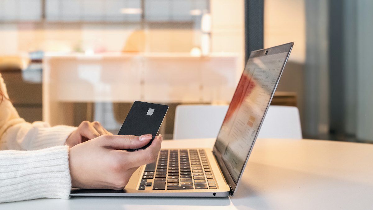 Online shopper browsing an e-commerce store on laptop and phone