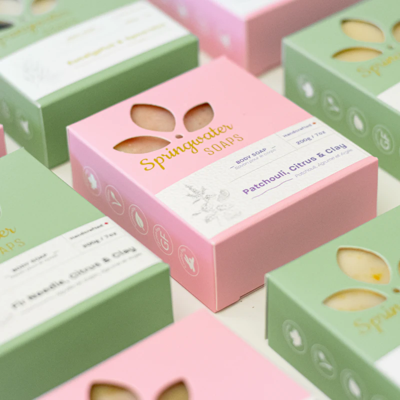 3D product packaging boxes with labels and branding elements in a studio setup